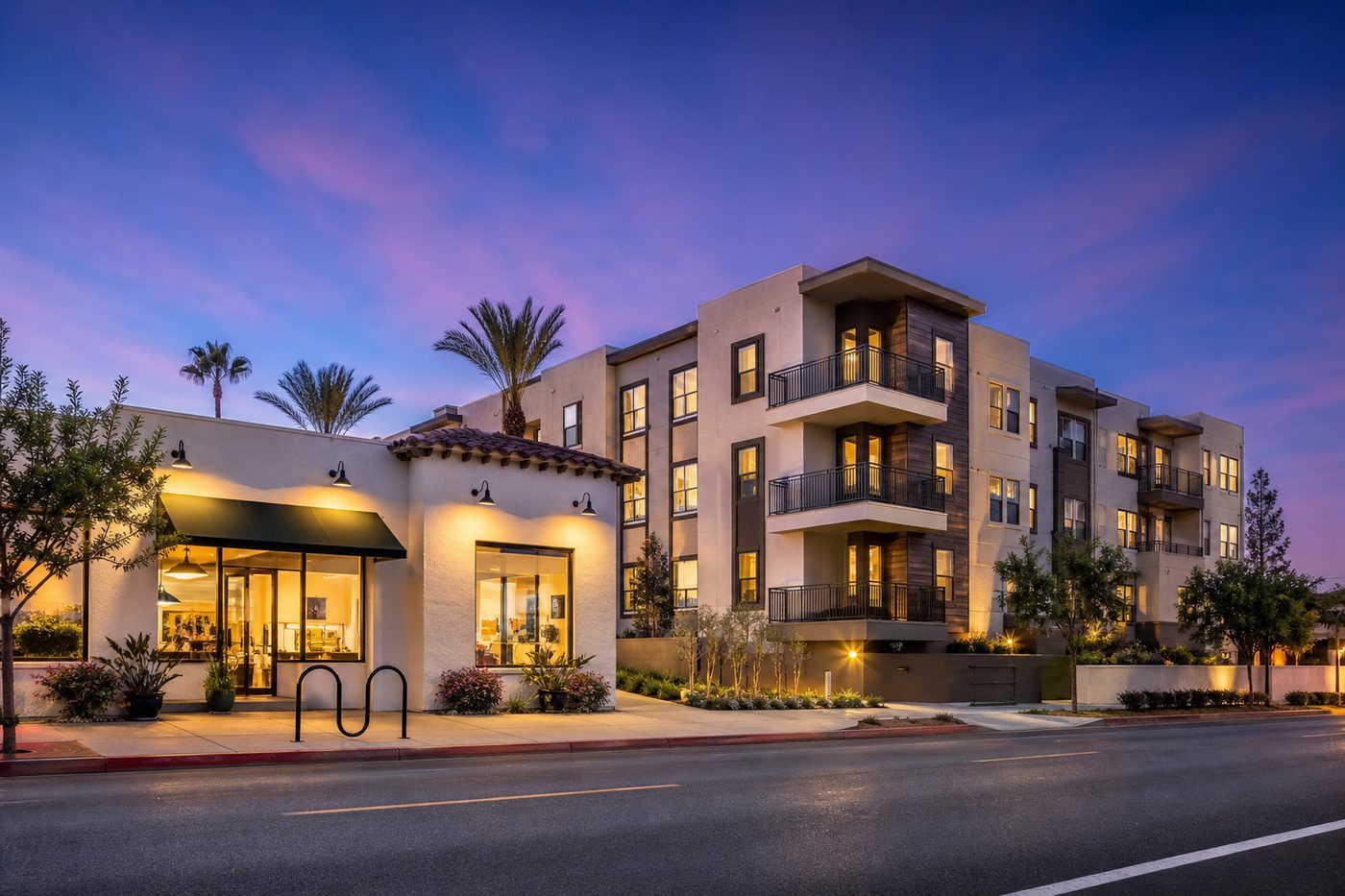 Mixed-use commercial and apartment building at dusk